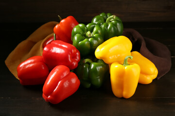 Heap of fresh colorful bell peppers on wooden background