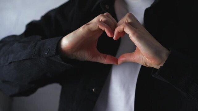 A man's hands imitate a heart.
Close-up of a loving gesture with his hands.