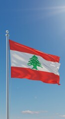 Lebanon flag waving in the wind against a clear blue sky.