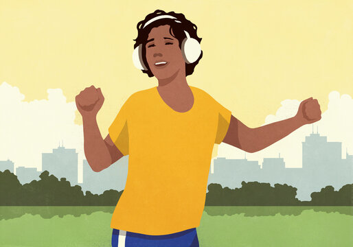 Carefree woman with headphones listening to music and dancing in sunny city park
