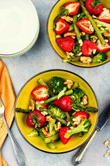 Vegan salad of green asparagus, strawberries.