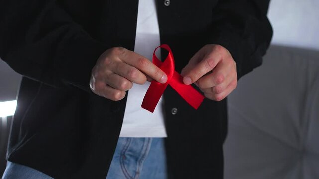 A red ribbon symbolizing solidarity with people living with HIV.
A symbol of HIV infection.
A red ribbon symbolizing support for people living with HIV.