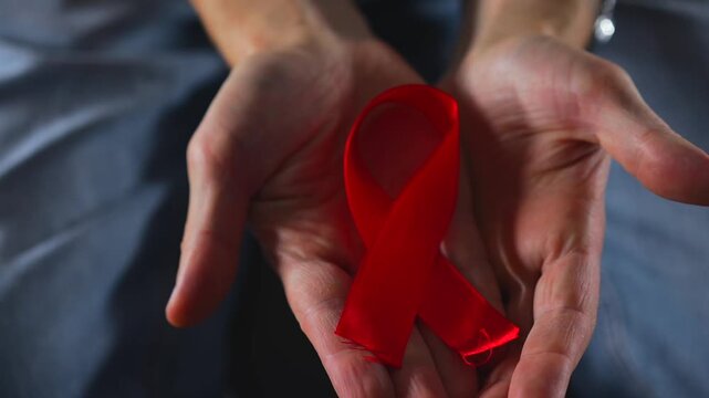 A red ribbon symbolizing solidarity with people living with HIV.
A symbol of HIV infection.
A red ribbon symbolizing support for people living with HIV.