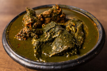Fufu with Abunabunu and Smoked Fish, Traditional Ghanaian Dish of Pounded Cassava and Plantain Served with Green Leaf Soup, a Popular Meal from West Africa.