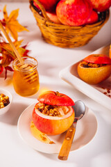 Sweet autumn dessert baked apples stuffed with muesli, nuts and honey.