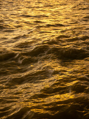 Golden Ocean Water Waves Surface Reflection at Sunset - Abstract Shimmering Sea Texture Background Pattern