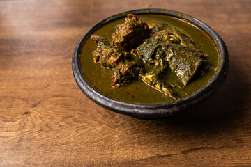 Fufu with Abunabunu and Smoked Fish, Traditional Ghanaian Dish of Pounded Cassava and Plantain Served with Green Leaf Soup, a Popular Meal from West Africa.