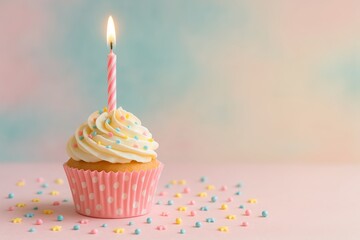 Cute cupcake with whipped frosting, sprinkles, and a lit candle in polka dot wrapper, on soft pastel background. Creative concept of birthday food. Ai generative