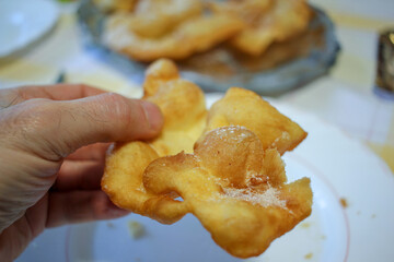 a man with a piece of pastry in his hand