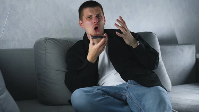 A man is yelling at his interlocutor on the phone and actively pestering him with something.
Telephone threats and conflict between people.
The man is yelling and getting very angry.