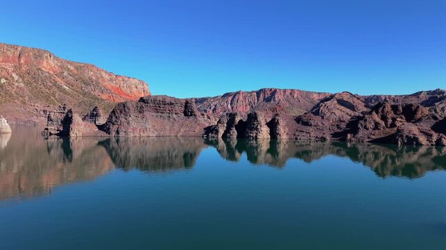 Valle Grande&rsquo;s blue waters, revealing the jagged cliffs of Ca&ntilde;&oacute;n del Atuel in San Rafael, Mendoza, Argentina, where wind-carved rock and desert silence meet alpine light, drone fast horizontal glide
