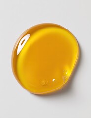 Golden liquid droplet on a white surface