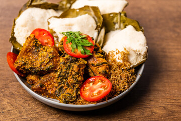Abolo, Soft Steamed Corn Cakes With Amatadzi Spicy Green Leaf Stew, Agushi, Fried Tuna Chunks, One-Man-Thousand Fish, Africa Ghana Traditional Dish