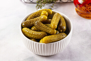 Marinated canned green cornichon cucumbers