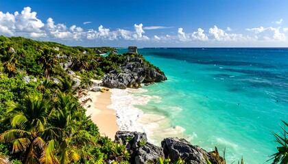 Turquoise waters meet a sandy beach and lush greenery, a historic structure perched on a cliffside overlooking the ocean