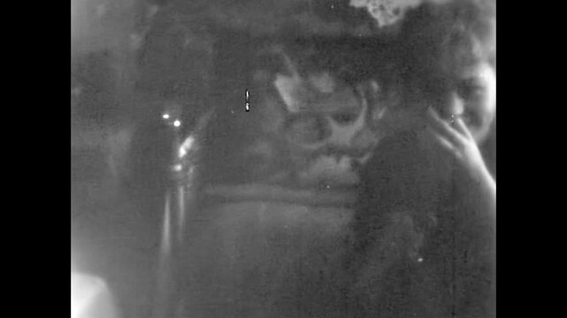 Old film, lonely woman drinking strong alcohol, vodka, eat snack in vintage apartment. stereotypical post-Soviet home culture. Satirical alcoholism. Vintage archive video. Archival retro 1960s realism