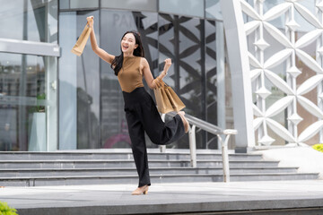 Happy woman experiencing joy while shopping and leaping