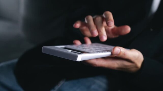 An investor uses a calculator for bookkeeping.
Banking and financial calculations.
A bank employee calculates interest or fees after bills are paid.
Banking, receipt, calculator, technology