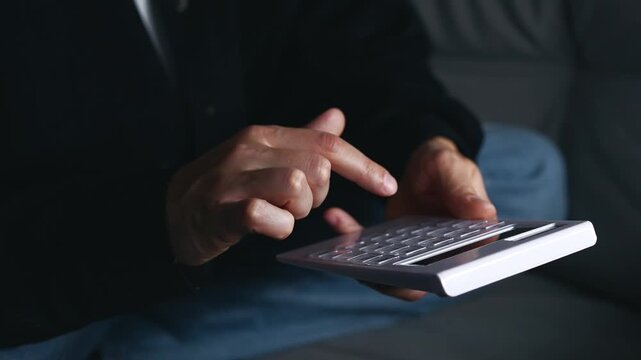 An investor uses a calculator for bookkeeping.
Banking and financial calculations.
A bank employee calculates interest or fees after bills are paid.
Banking, receipt, calculator, technology