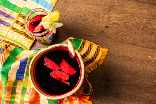 Sobolo, Hibiscus Drink, Vibrant red drink made from dried hibiscus petals, pineapple peels, ginger, cloves, and sweetened to taste