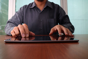 Businessman Using Tablet on Wooden Desk