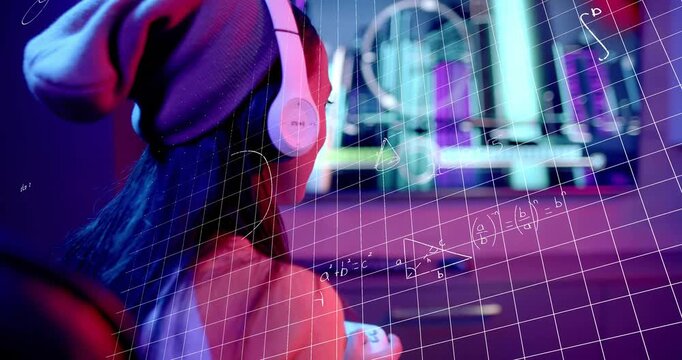 Student holding controller, gazing and launching grid overlaying equations for education