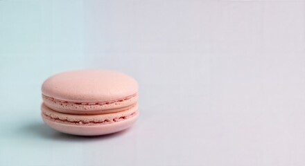 Fototapeta premium Single pink macaron on pastel background food