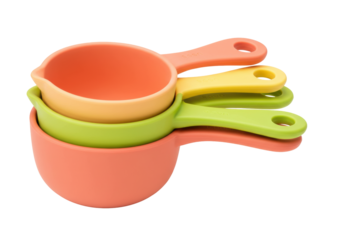 Isolated measuring cups set for baking and cooking in colorful orange, yellow, green tones