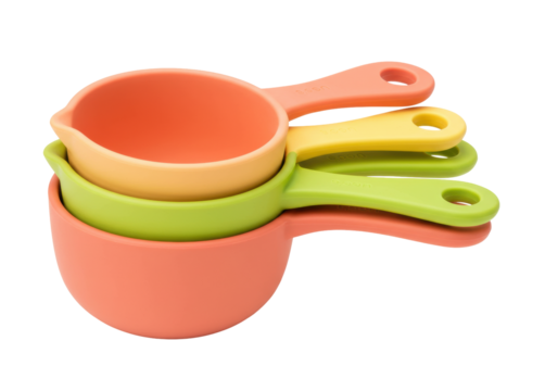 Isolated measuring cups set for baking and cooking in colorful orange, yellow, green tones