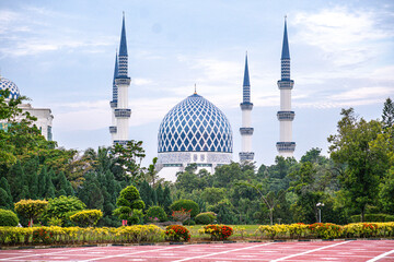 Landscape view of Sultan Salahuddin Abdul Aziz Mosque with lush greenery