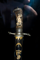 Medieval saber on a black background. Selective focus.