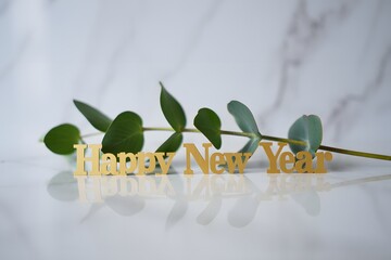 Happy new year greeting with green leaves isolated on white background