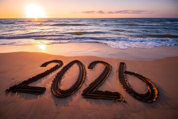 Sunset on beach with 2020 written in sand