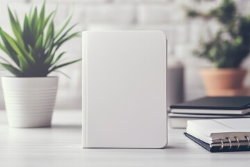 Notebook on table with plants and minimal decor in a calm workspace