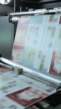 Vertical: Newspapers being packed in a busy printing factory, where precision, speed, and repetition define the rhythm of modern information.