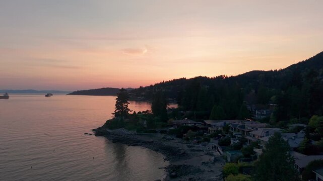 A scenic beautiful golden sunset over a coastline near a luxury suburban neighborhood in Proctor Avenue, Canada.