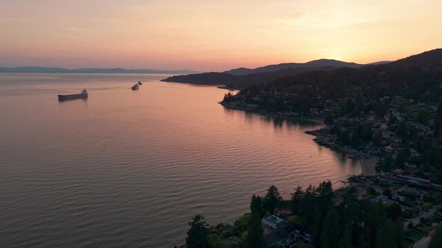 A beautiful scenic drone shot of a the sun setting in Proctor Avenue, Canada.
