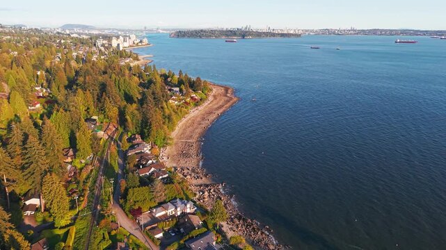 A scenic drone shot of the coast of Proctor Ave in West Vancouver with a view of Dundarave and Vancouver City on the horizon.
