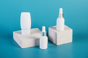 Cosmetic product in tube, bottle, lotion or serum with stylish props on red background. 