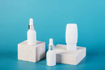 Cosmetic product in tube, bottle, lotion or serum with stylish props on red background. 