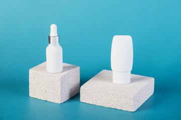 Cosmetic product in tube, bottle, lotion or serum with stylish props on red background. 