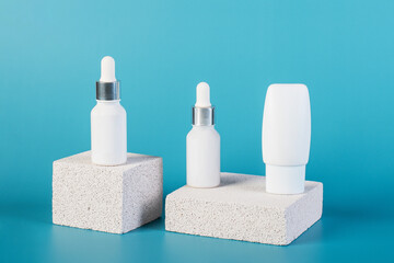 Cosmetic product in tube, bottle, lotion or serum with stylish props on red background. 