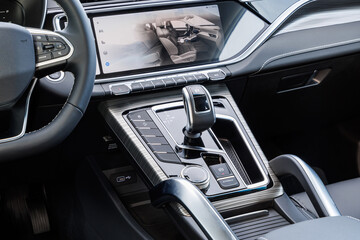 Modern car interior with digital dashboard, gear shifter and drive mode selector