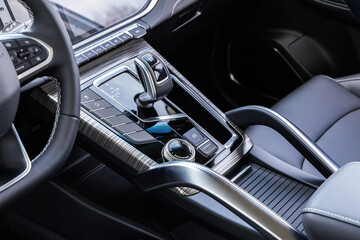 Luxury car interior with high-tech gear selector, rotary dial and touch-sensitive control panel