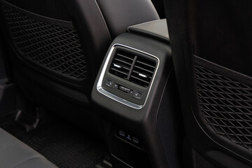 Rear center console with dual air vents, climate control panel, USB ports and 12V outlet