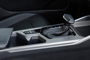 Center console with automatic gear shifter, electronic parking brake, red indicator button and stitched upholstery