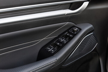 Driver-side car door with power window switches, child lock button, mirror joystick and metallic handle