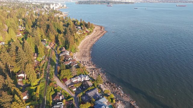 an aerial shot of luxury homes along the coastline of Proctor Avenue, West Vancouver with Vancouver City over the horizon.