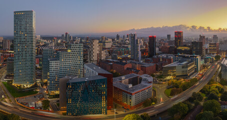 Aerial long-exposure panorama of Manchester skyline and Mancunian Way at dawn from the east side.