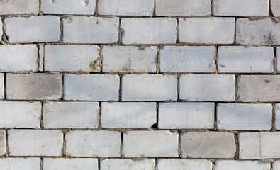 A brick wall with a few missing bricks